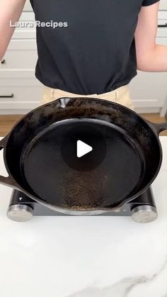 a person standing over a frying pan on top of a kitchen counter with the lid down