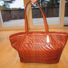 We Have A Pre-Owned Handbag By Cole Haan! Brown. Woven. Tote. Magnetic Closure. Gold Tone Hardware. Inside Zippered Pocket And 3 Open Pockets. Measures 18.5" High, 11" Wide, 6" Deep And Strap Drop Is 9.5". Minor Wear On The Corners. Marks On The Handles. 1 Piece Of Weaving Is Coming Apart - See Photo Number 6. Clean Interior. Super Nice Pre-Owned Bag By Cole Haan! Comes From A Smoke Free Home. Handwoven Brown Handheld Beach Bag, Brown Woven Leather Tote Bag, Brown Woven Leather Bag For On-the-go, Brown Straw Tote Bag With Gold-tone Hardware, Cole Haan Woven Leather Bag, Leather Handbags Tote, Cole Haan, Womens Tote Bags, Tote Handbags