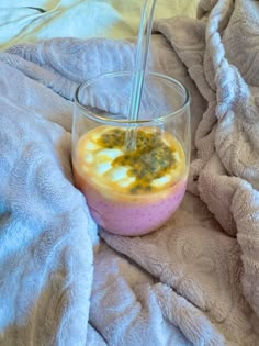 a glass with some food in it on a blanket