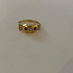 Antique 18k Garnet Diamond Gypsy Ring From Birmingham C 1901. This Yellow Gold Edwardian Ring Features Two Round Cut Garnets And One European Cut Diamond In A Marquis Setting. The Shoulders Of This Antique Ring Have A Columnar Architecture To Them. Ring Is Sized To 6 3/4; There Is A 18k Stamp Inside. Heirloom Yellow Gold Multi-stone Diamond Ring, Heirloom Yellow Gold Ruby Signet Ring, Heirloom Ruby Signet Ring In Yellow Gold, Yellow Gold Ruby Signet Ring Hallmarked, Yellow Gold Ruby Signet Ring For Anniversary, Antique Multi-stone Yellow Gold Cluster Ring, Antique Three Stone Gold Jewelry, Antique Gold Three-stone Jewelry, Antique Multi-stone Cluster Ring In Yellow Gold