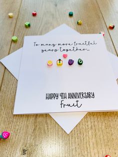 an anniversary card with some candy on it and the words happy 44th anniversary fruit written in black ink