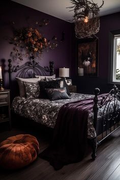 a bedroom decorated in black and purple with an iron bed frame, velvet pillows, and decorative artwork on the wall