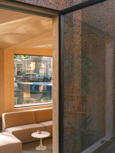 a living room filled with furniture next to a window covered in frosted glass doors