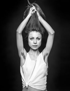 black and white photograph of a woman with her hands on her head