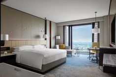 a hotel room with a large window overlooking the city