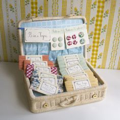 a basket filled with lots of different types of buttons and pins on top of a table