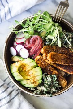 a close up of a bowl of food with meat and veggies on it