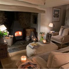 a living room filled with furniture and a fire place next to a fireplace in a house