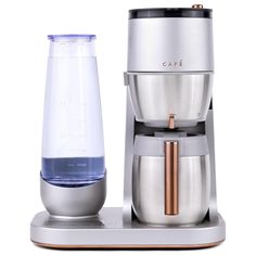 a coffee maker with a glass next to it