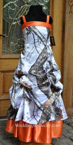 a dress made to look like a tree camo wedding gown with an orange sash