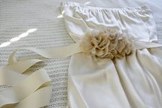 a close up of a bed with white sheets and ruffles on the pillow