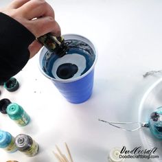 someone is painting the inside of a cup