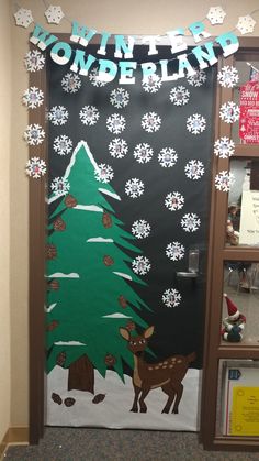 a door decorated with paper snowflakes and a reindeer standing in front of a christmas tree