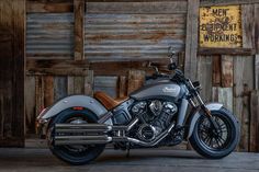 a motorcycle parked in front of a wooden building