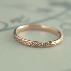 At a dainty 2.4mm wide by 1.5mm thick, our Skinny Flourish Ring is the perfect thinner wedding band or stacking ring. You simply can't do without it! Pair it with your other stacking rings or wear it alone as a symbol of your love. It's a stunning band. It is hand cast just for you in our studio from solid 10K gold in your choice of color and meticulously hand polished to perfection. Also available in 14K gold here: https://www.etsy.com/listing/291070075 Blazer Arts is a family-owned and operate Classic 14k Gold Wedding Jewelry, Gold Engraved Ring For Wedding With Classic Design, Delicate Engraved Round Ring For Wedding, Delicate Engraved Round Wedding Ring, Delicate Engraved Wedding Ring, Yellow Gold Engraved Stackable Wedding Rings, Yellow Gold Stackable Rings With Intricate Design For Wedding, Engraved Yellow Gold Stackable Rings For Wedding, Engraved Yellow Gold Stackable Wedding Rings