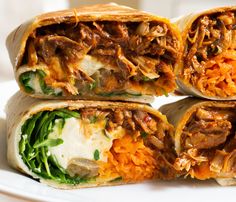 three burritos stacked on top of each other with shredded cheese and meat in them