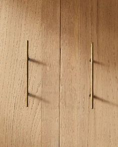 two wooden cupboards with metal handles on them