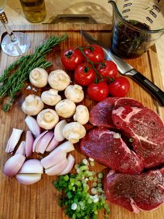 some meat and vegetables are on a cutting board