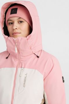 a woman wearing a pink and white jacket with a hood on her head, she is looking at the camera