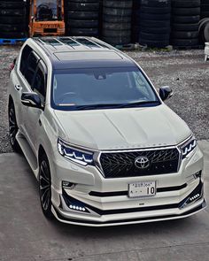 the front end of a white suv parked in a parking lot