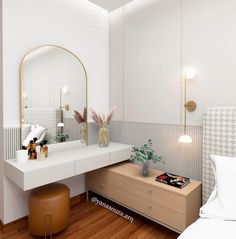 a bedroom with a vanity, mirror and stool next to a bed in the room