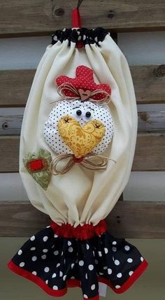 a stuffed animal hanging from the side of a wooden fence with polka dots on it