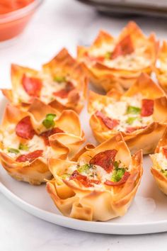 small appetizers are arranged on a white plate