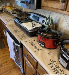 the kitchen counter has many pots and pans on it, including an electric pressure cooker