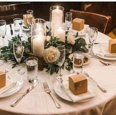 the table is set with candles and place settings