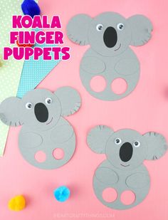 three koala finger puppets are shown on a pink background with pom poms