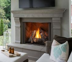 a living room with a fireplace and television above it