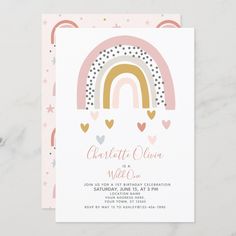 a pink and gold rainbow themed baby shower with hearts on it's side, in front of a white marble background