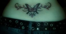 a woman with a butterfly tattoo on her stomach