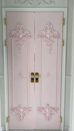 a pink door with ornate designs on it