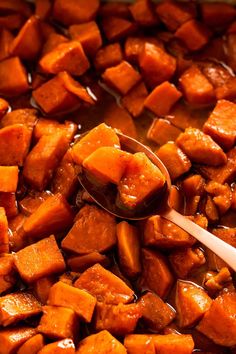 a spoon is being used to stir sweet potatoes