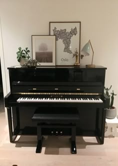 a black piano sitting in the middle of a room