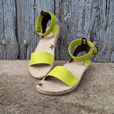 Espadrille sandal with wide ankle strap. Boho style. On semi-flat sole. Made of leather and interior lined with double leather. The sole is made of natural jute, back height 3cm, front height 1.5cm It has straight lines on the strap in front of the foot, and a 2.5 cm wide strap on the ankle bracelet, with a round buckle. Made of pistachio green leather. Ask us about availability of other colors. You are going to choose sandals designed, patterned and manufactured in my Artisan Workshop for you, Summer Espadrille Sandals With Ankle Strap, Summer Ankle Strap Espadrille Sandals, Green Sandals With Woven Sole For Beach, Green Round Toe Espadrilles, Green Ankle Strap Sandals With Removable Insole, Spring Green Sandals With Woven Sole, Green Sandals With Leather Sole For Summer, Green Open Toe Sandals With Woven Sole, Summer Wedge Sandals With Ankle Strap And Rubber Sole