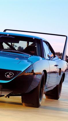 a blue sports car parked on the beach