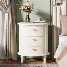 a white nightstand with flowers on top of it