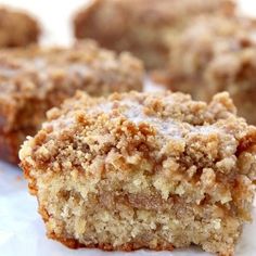 several pieces of cake sitting on top of a piece of white paper with crumbs