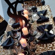 the table is set with candles and black napkins for an elegant dinner or party