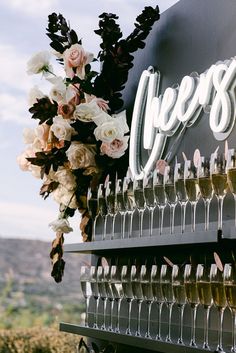 a bunch of wine glasses sitting on top of a table next to flowers and candles