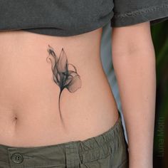 a woman with a flower tattoo on her stomach