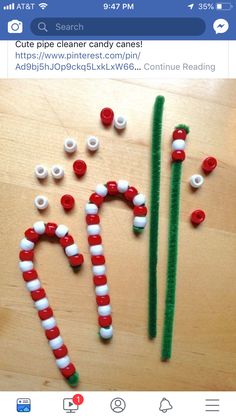 some candy canes are sitting on a table with pins in the shape of letters