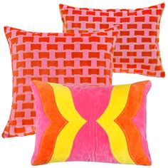 three pillows with different colors and patterns on them