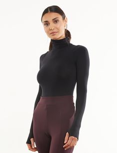 Made from a matte-black, seamless microfiber fabric with endless stretch, our sleek Ballet Turtleneck Bodysuit features thumbhole details and is finished with a raw-cut thong bottom. Pair under a sleeveless dress or with a wide-legged pant for a look as functional as it is fashionable. Product Details Luxury microfiber blend (87% nylon, 12% elastane, 1% cotton) Fit-tested by real women Seamless construction High stretch and recovery One size fits most Superior body contouring Snap gusset closure Ballet Body, Turtleneck Bodysuit, Black Seamless, Jennifer Fisher, Fancy Pants, Long Sleeve Turtleneck, Body Contouring, Faux Leather Leggings, Leather Leggings