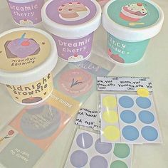 several ice creams and stickers on a table