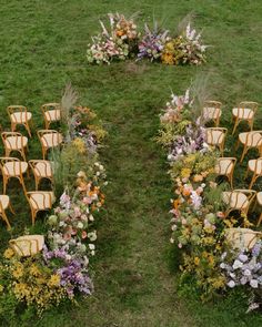 an arrangement of chairs and flowers in the grass