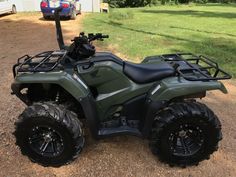 a green four - wheeler parked in front of a house