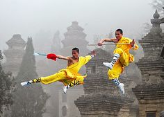 two men in yellow outfits are doing tricks